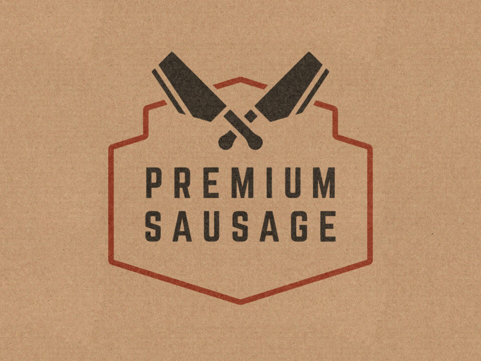 Premium Sausage Rebrand Project. Grain elevator shaped crest emblazoned with 2 meat cleavers shaped like the province of Alberta.