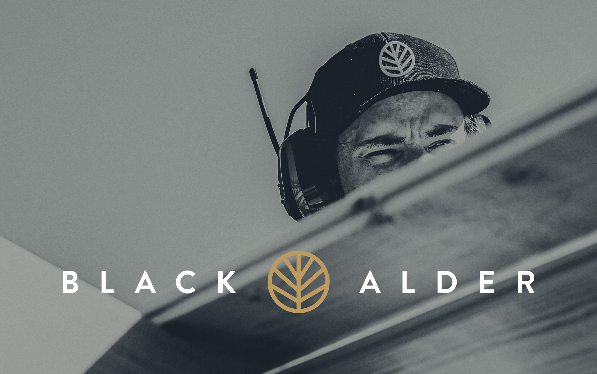 Black Alder Logo with construction worker with Black Alder cap