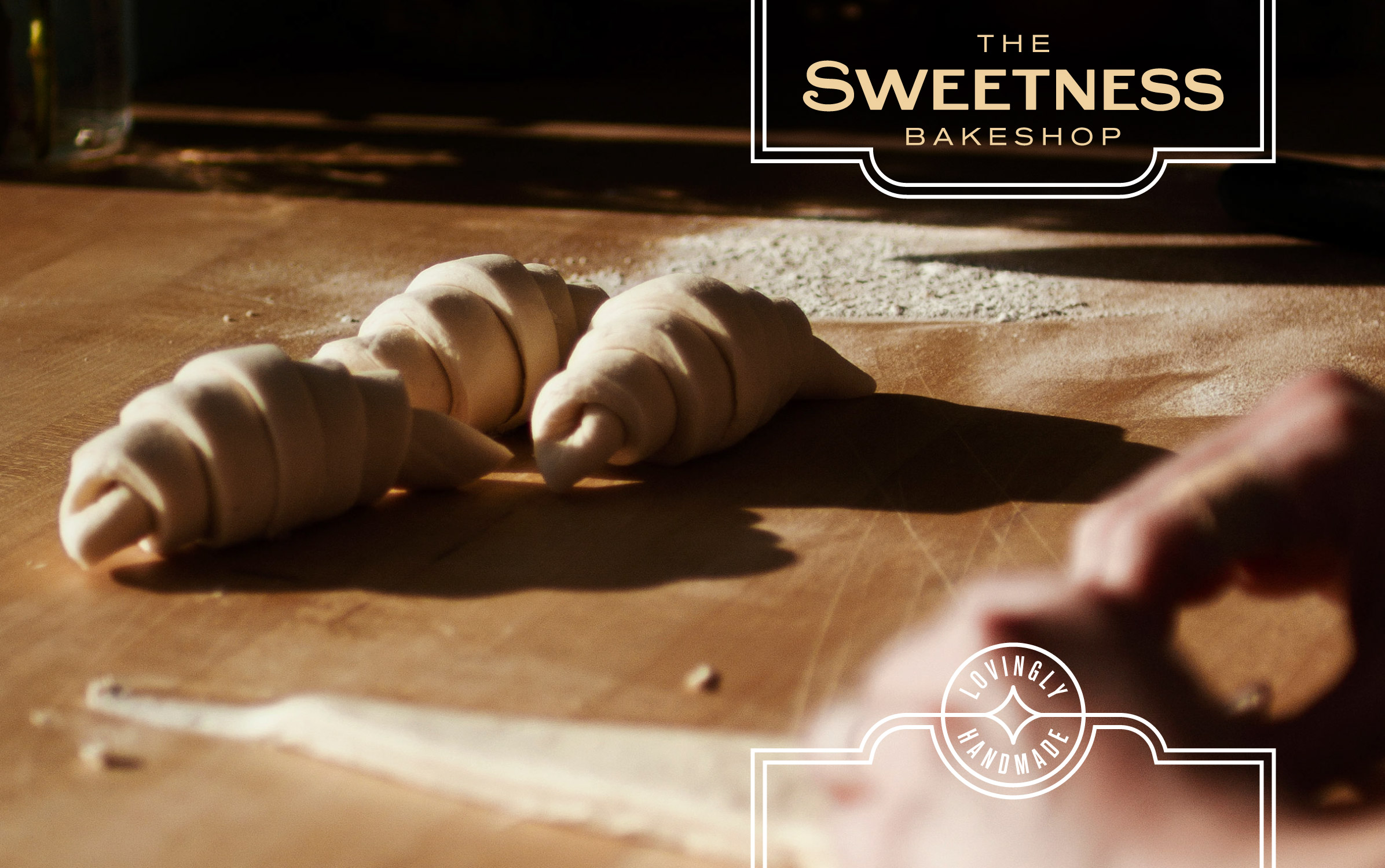 The Sweetness Bakeshop logo and croissants being rolled